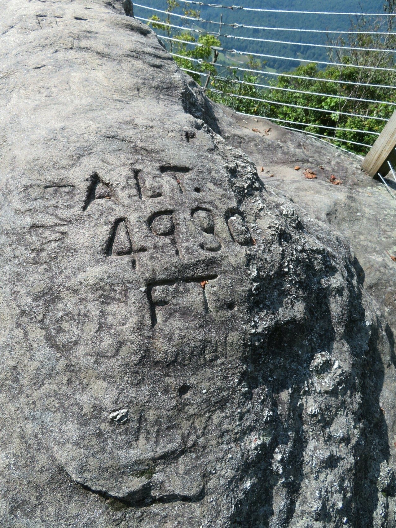Altitude information etched into a large bolder