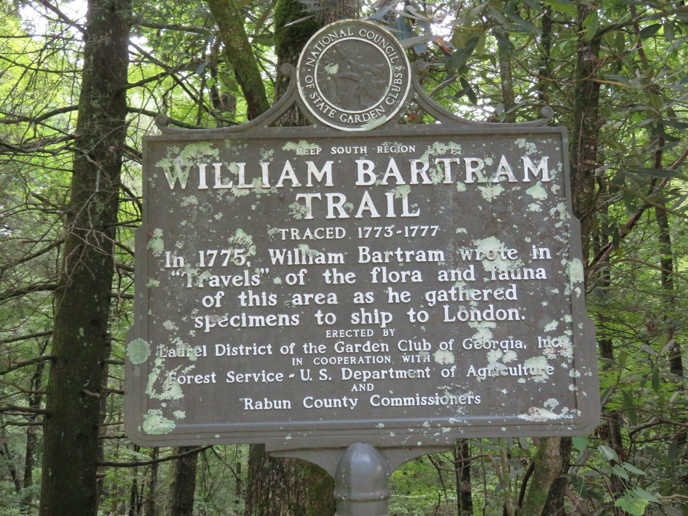 Weathered Bartram Trail historical sign headed down to Warwoman Dell.
