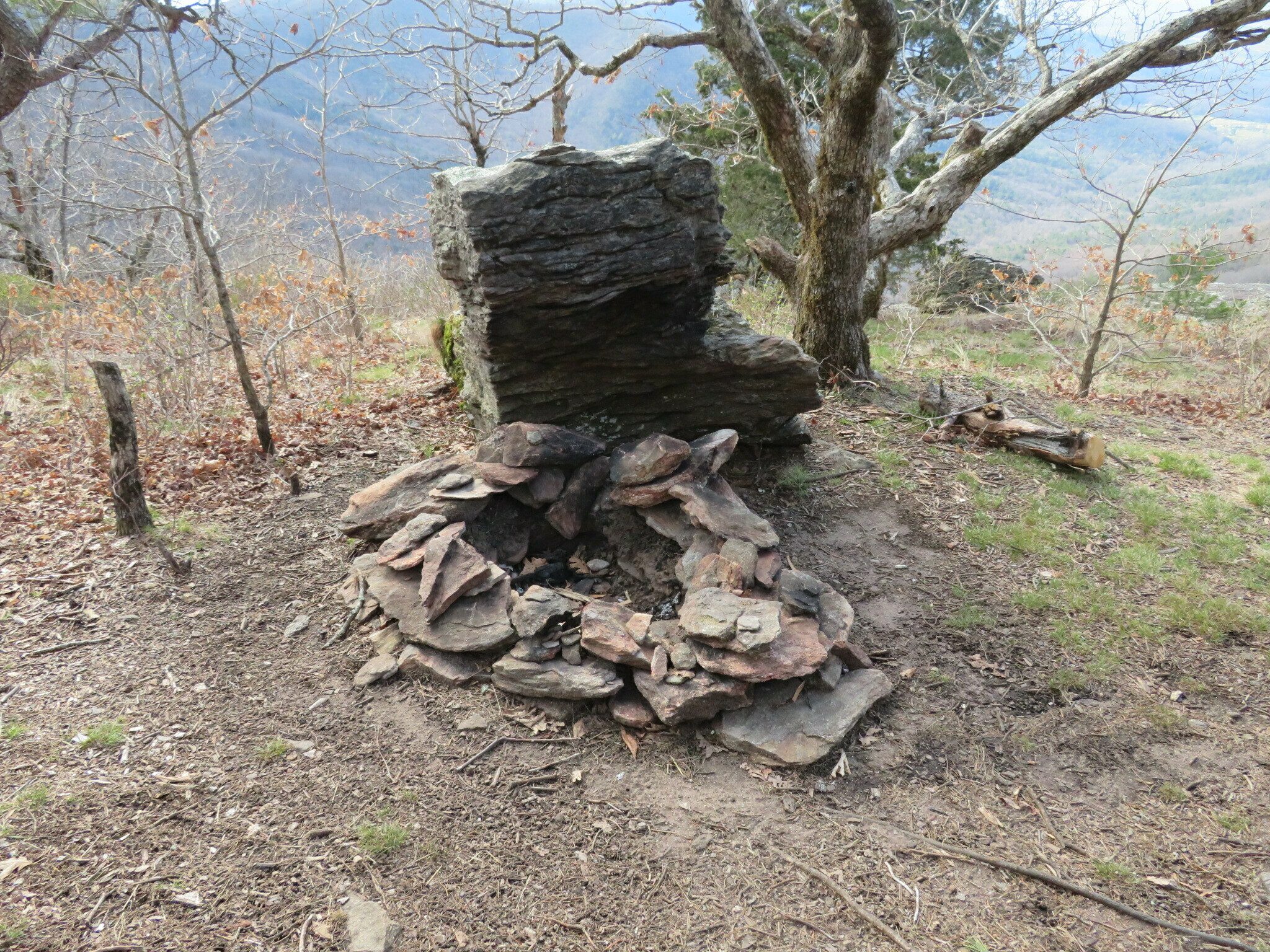 A nicely built fire pit with a heat reflector at a campsite on Cow Rock.