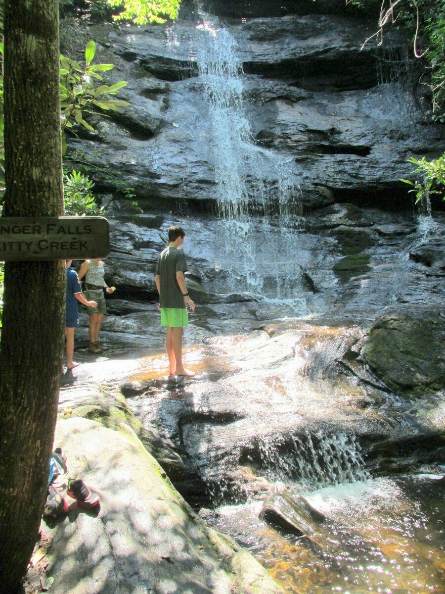 Huck checking out Ranger Falls.  Thor and Heather partially hidden behind the sign.