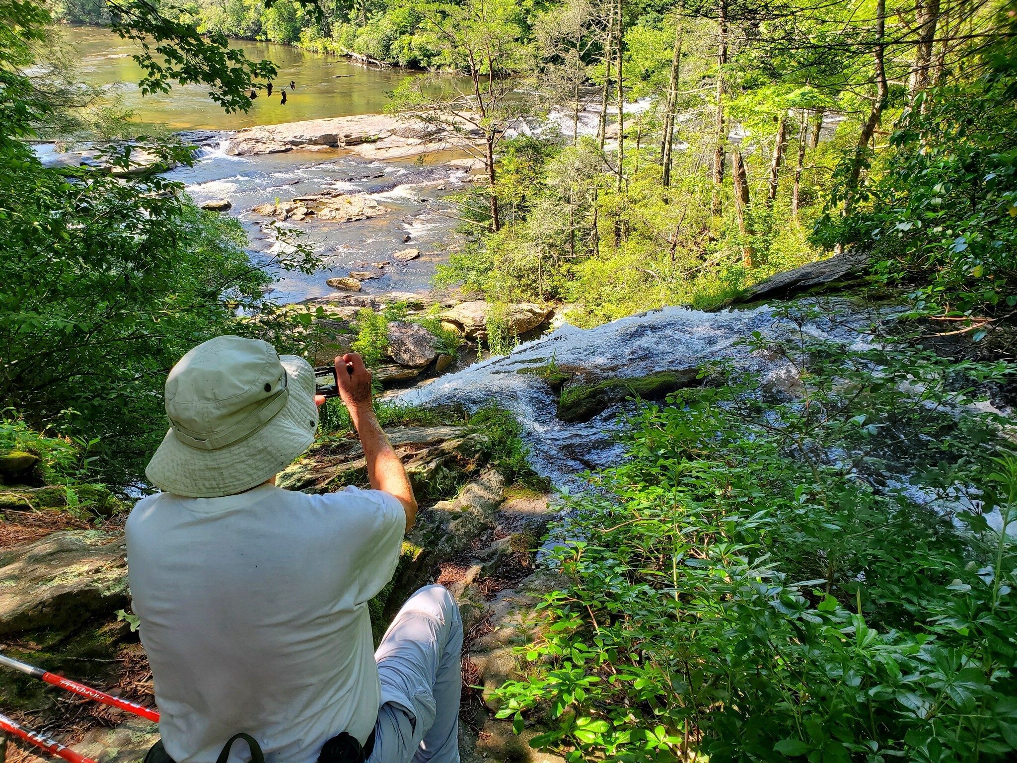 Dick Metzgar taking a photo atop Dicks Creek Falls.