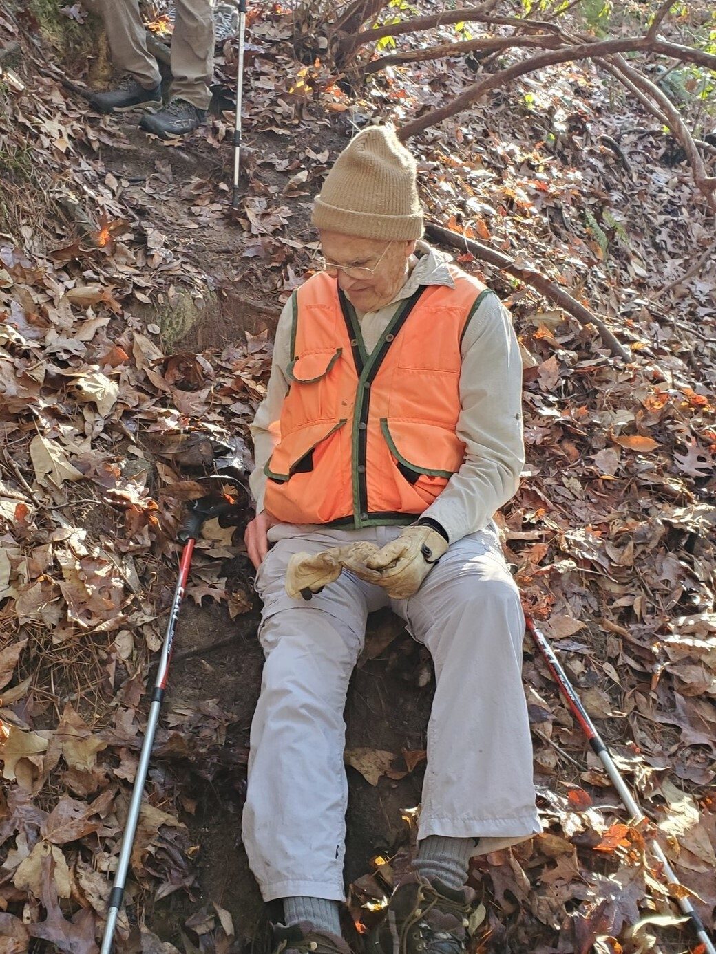 Dick Metzgar using the safe, "on your rear" technique for getting down a step, slippery hill.