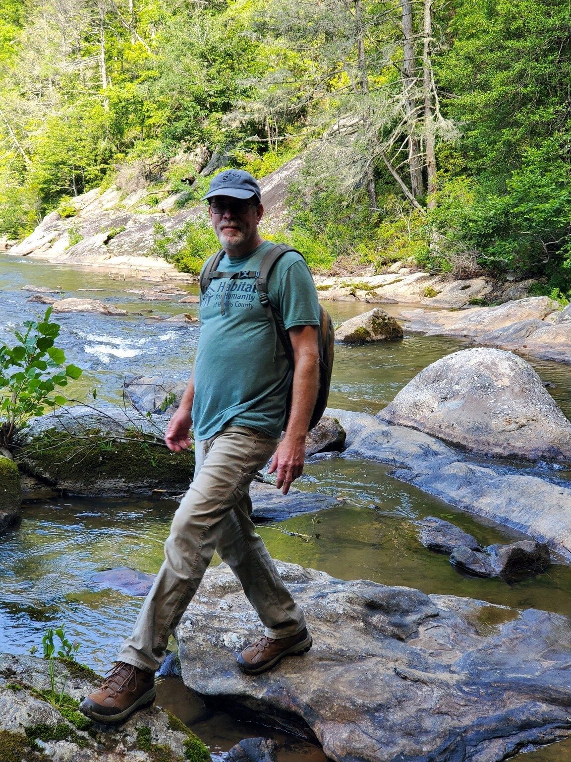 Rex Wade carefully rock-hopping back to the shore after taking a better look at the falls.