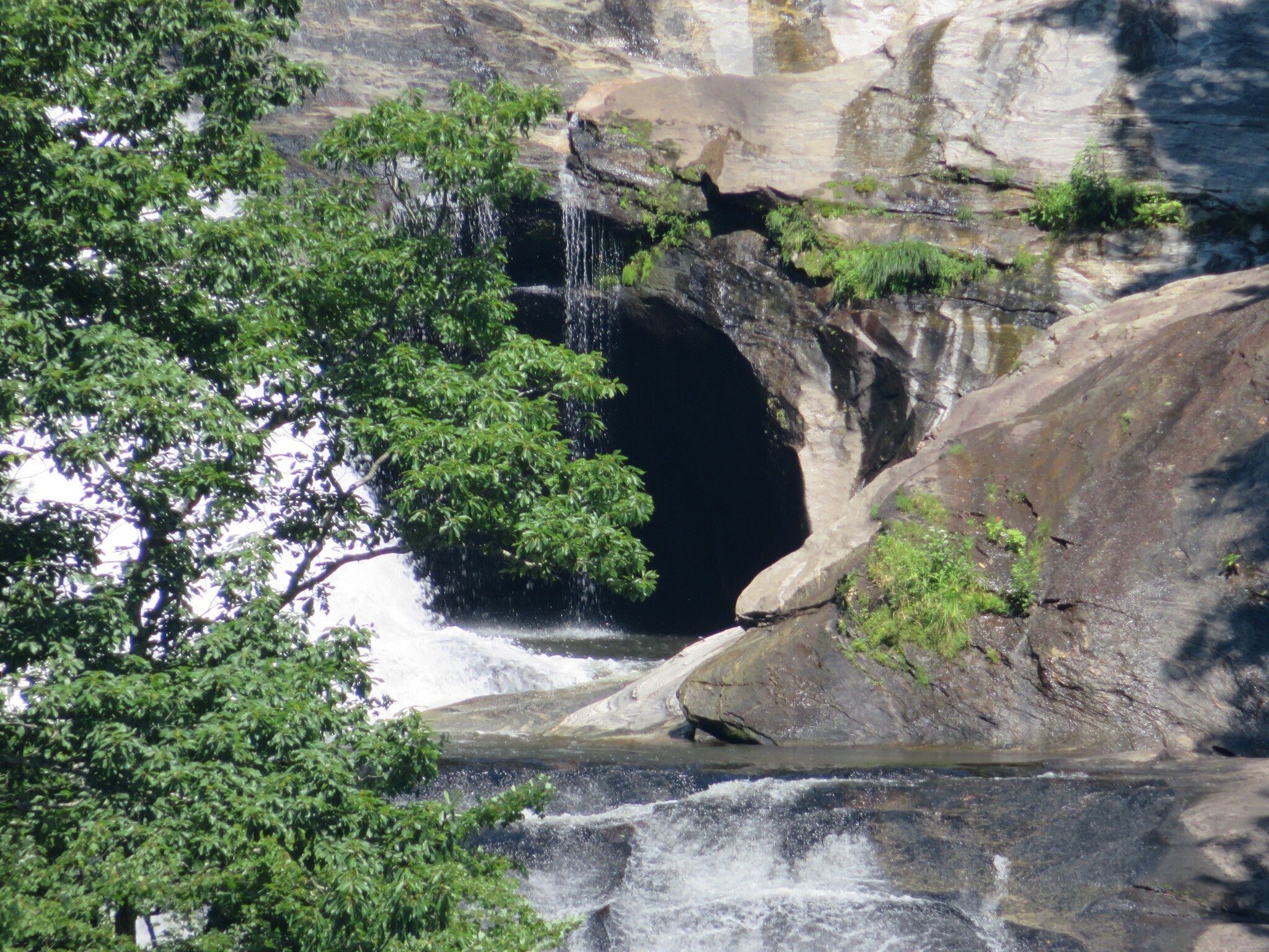 What appears to be a cave in the upper section of the falls.