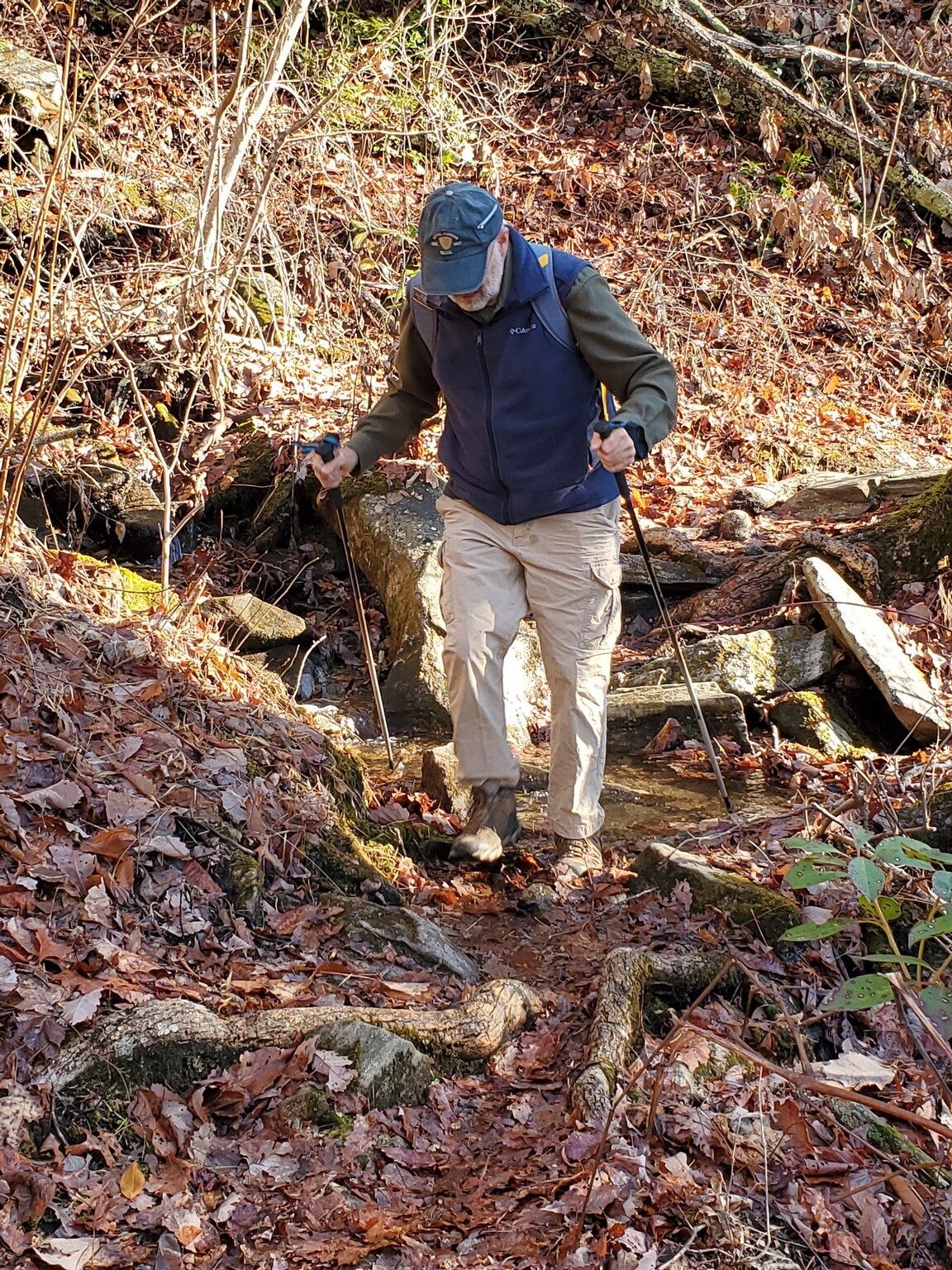 Ray crossing one of the many drainage swales crossing the trail.