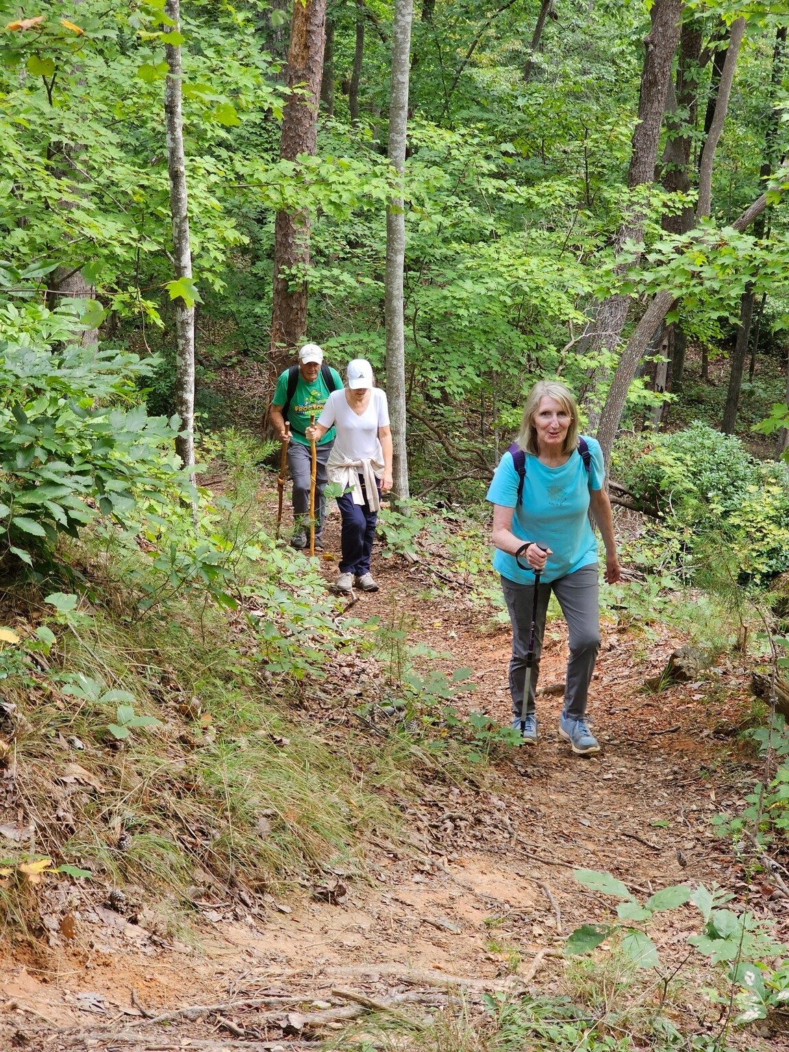 A easy hike, but there are still a few hills.  Almost at the top, Debbie.