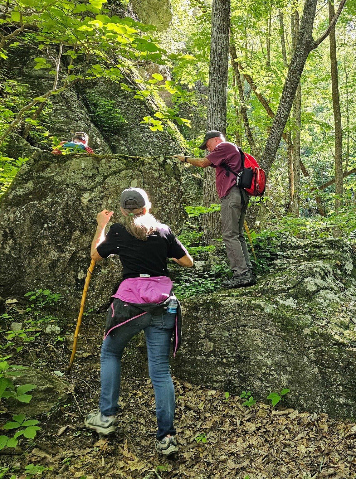 Ken and Claudia Pardue climbing some large boulders on their way up to Bull Cove Falls.
