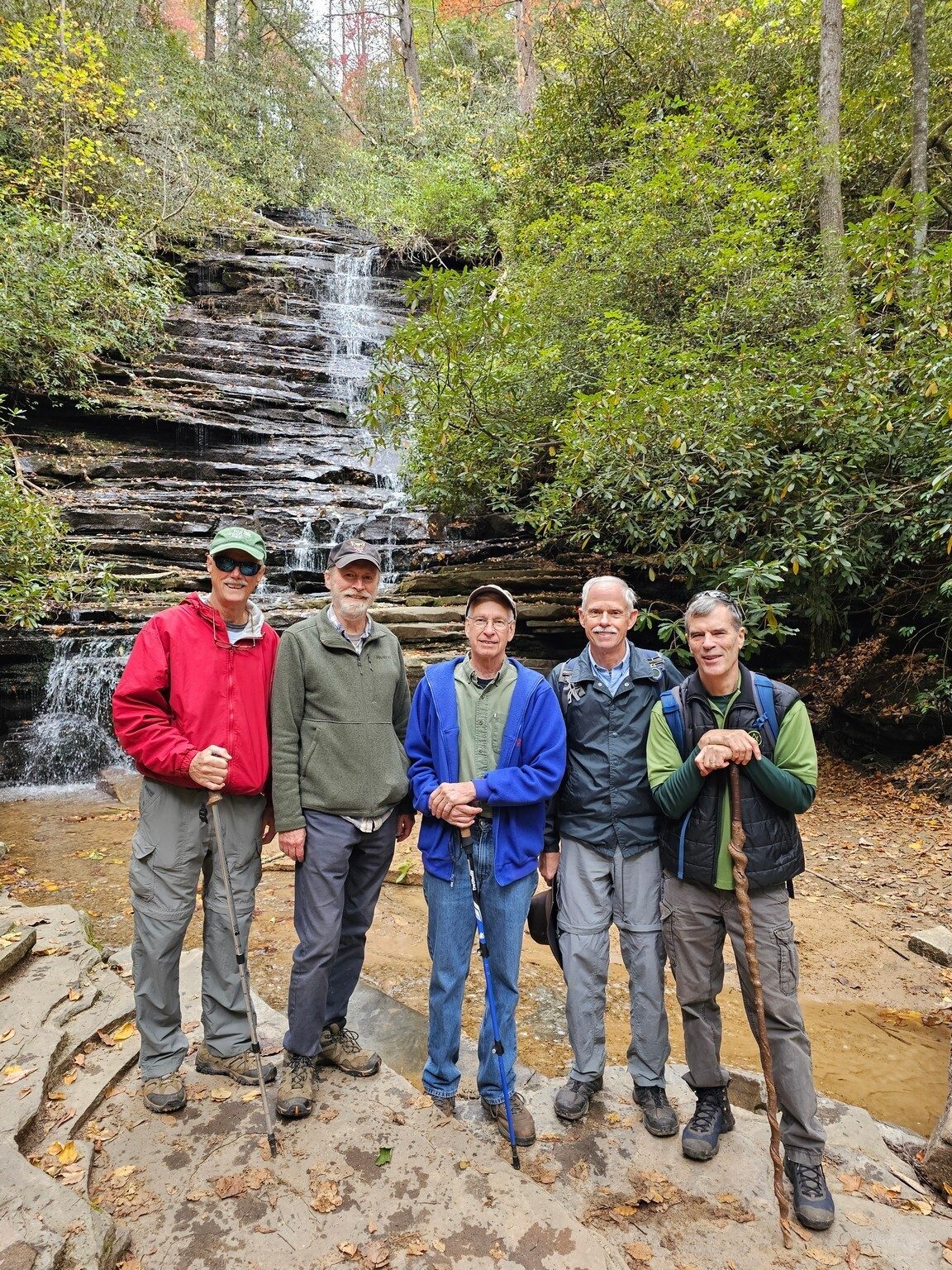 The lady hiker smiles must be because of their handsome male companions.