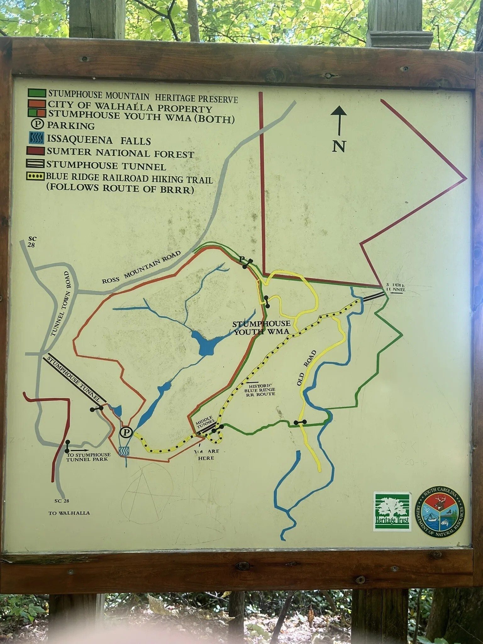 This trail map posted along the way shows this trail does really follow the planned railroad path.