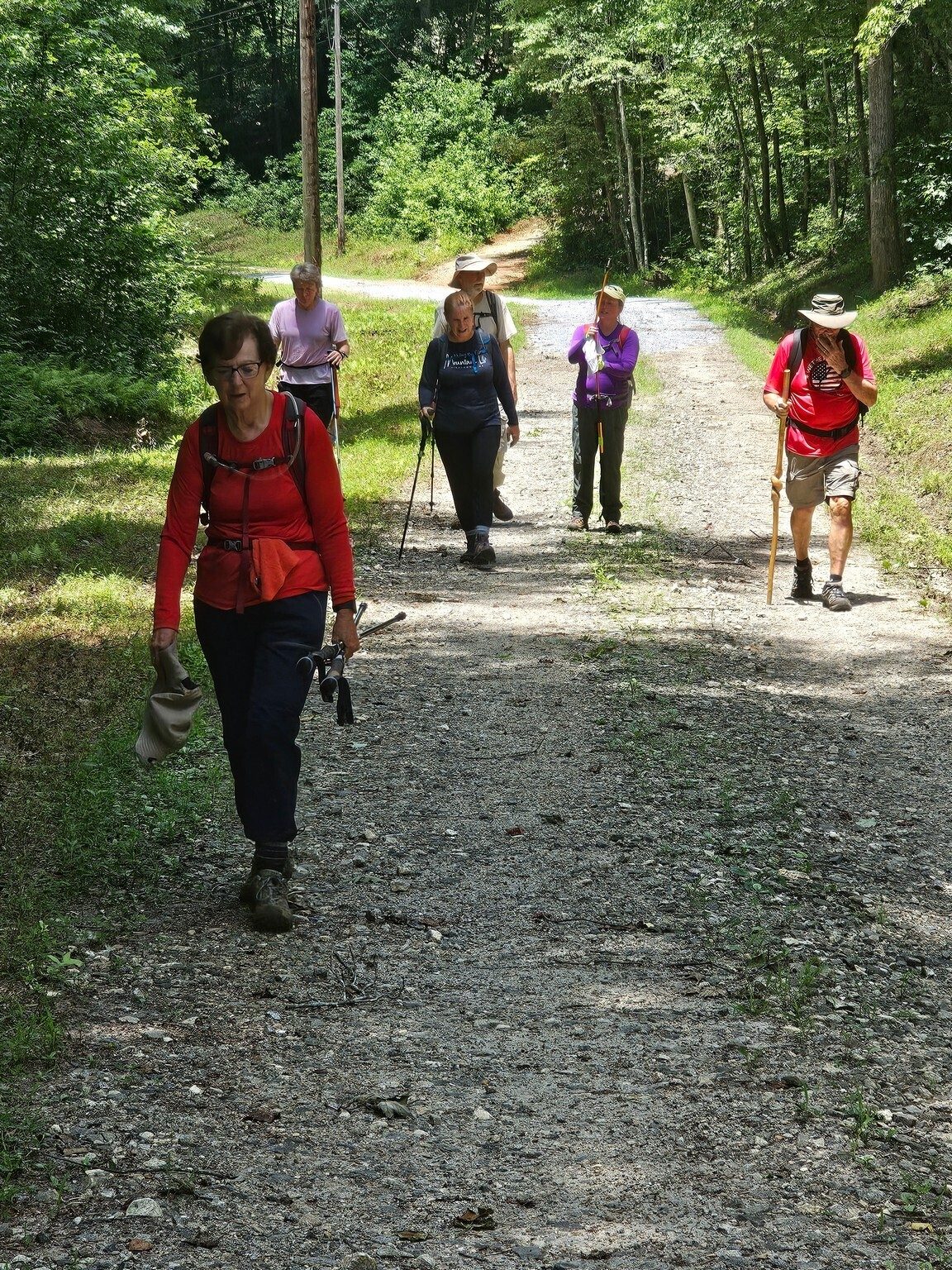 A tired group of hikers about to finish this hike