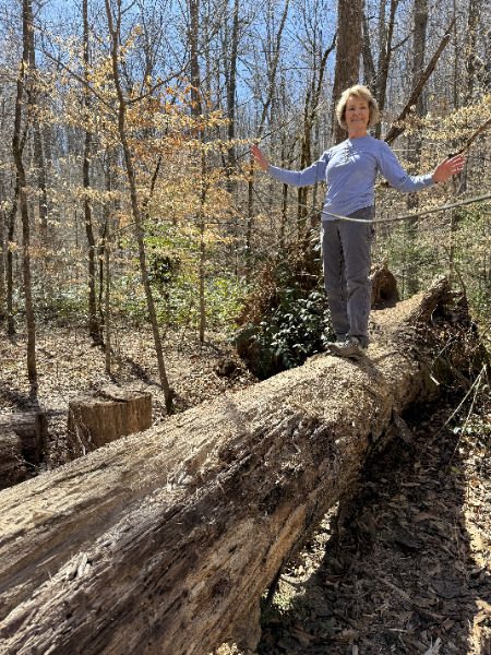Beth fooling around on one of the many blowdowns nearby the trail.  Photo by  Linda Shultz???