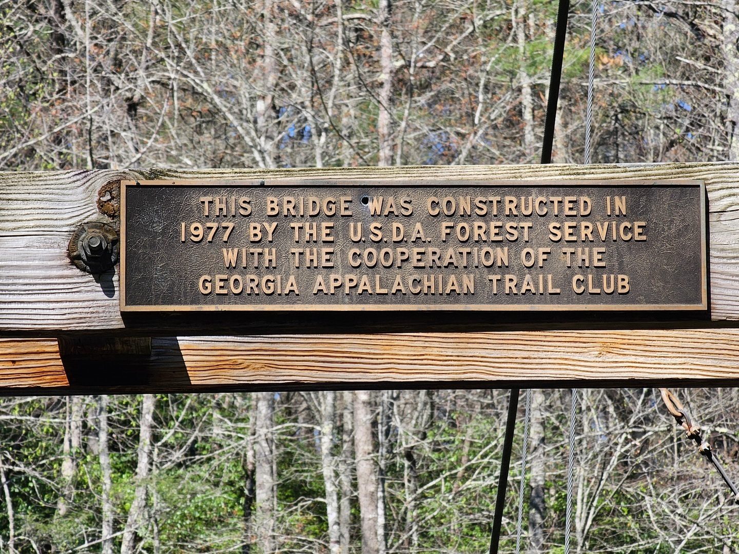 A plaque on a support crossbeam providing a little history of the bridge.