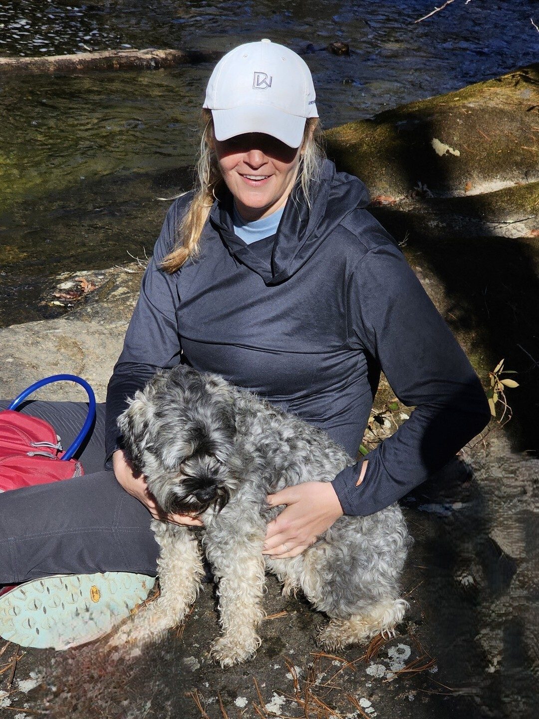 Paige and a new trail dog for us, "Bear," taking a break at the river.
