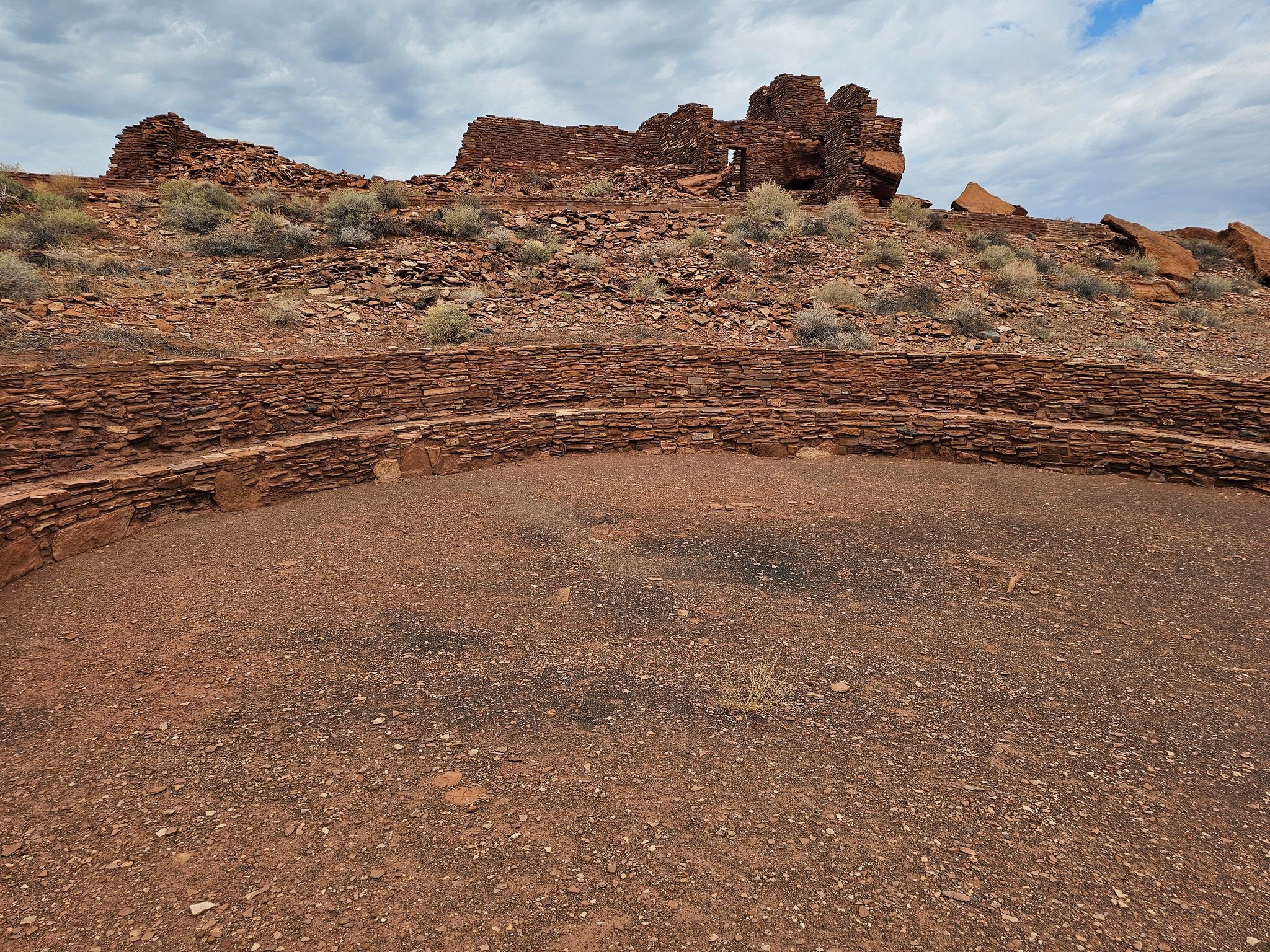 The ceremonial ball court with the Wupatki pueblo in the background.