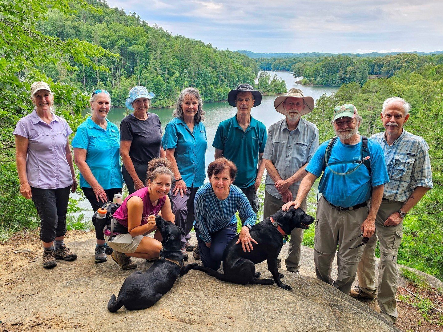 Today's hikers on Raven Rock above Lake Keowee (L-R) Back: Linda, Betty, Sharon, Renee, Gerald, Matt & Toby, Jack & Mike; Front: Heather & Toby and Jenny.